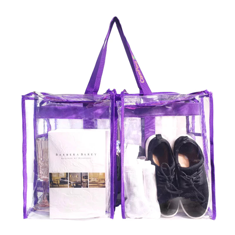 Purple clear large camping bag with black shoes and a white garment inside 2 front pockets