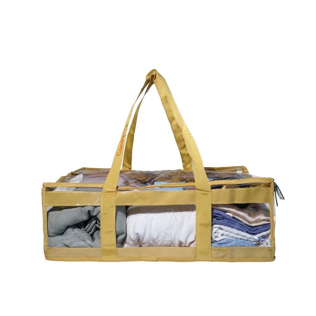 Side view of sand CamPaq clear under bed bag filled with linen