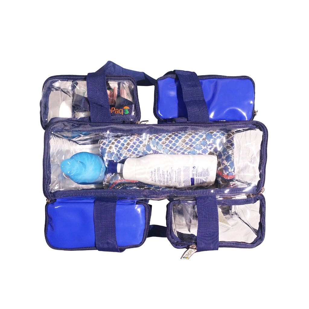 Top view of navy CamPaq clear toiletry bag  showing 5 pockets with toiletries inside